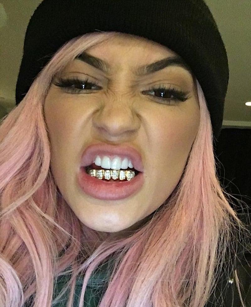 Kylie wearing the $15,000 grill which Tyga bought her. Pic: kinggoldchains/instagram