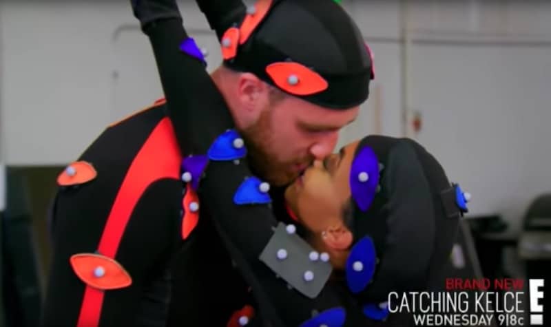 Maya gets a kiss from Travis during the video game shoot on this week's Catching Kelce