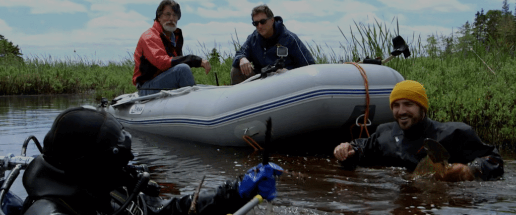 The team explore the Oak Island swamp with a diver and inflatable