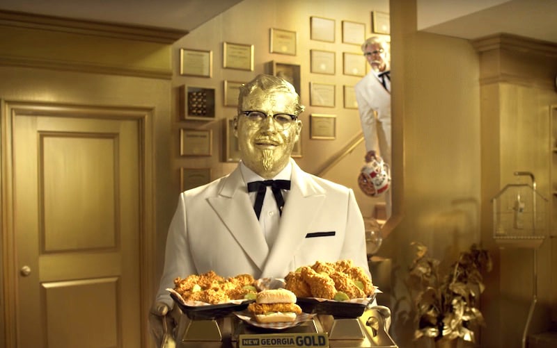 Zane's "gold" colonel in the KFC Super Bowl ad as Riggle's lurks in the background