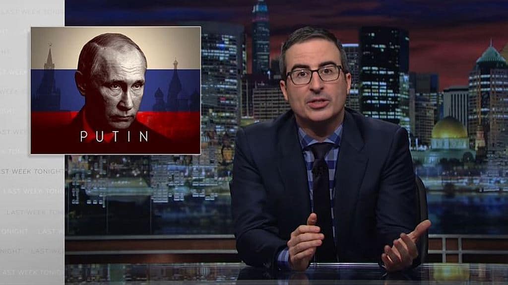 John Oliver with a picture of Vladimir Putin behind him