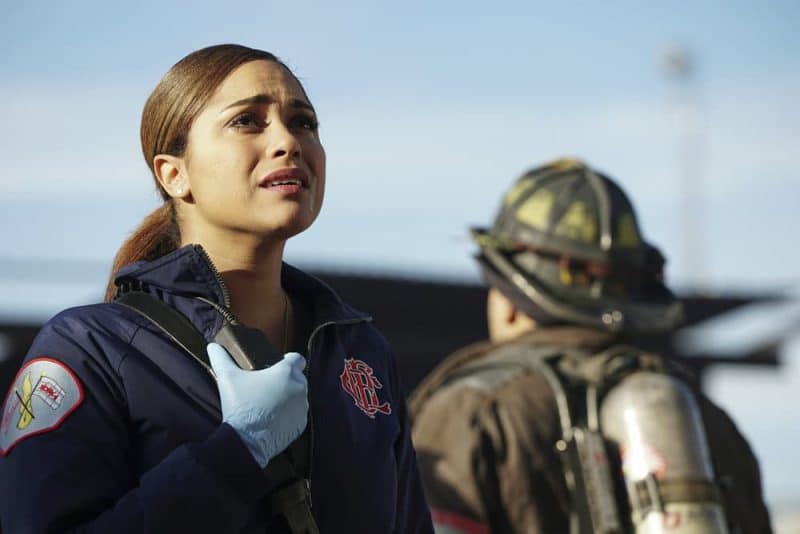 Monica Raymund as Dawson looking up at the building and holding her radio