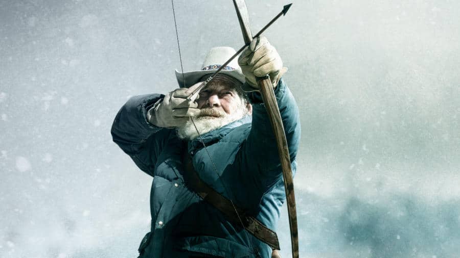 Tom Oar pulling an arrow back from a bow in a promotional Mountain Men photo