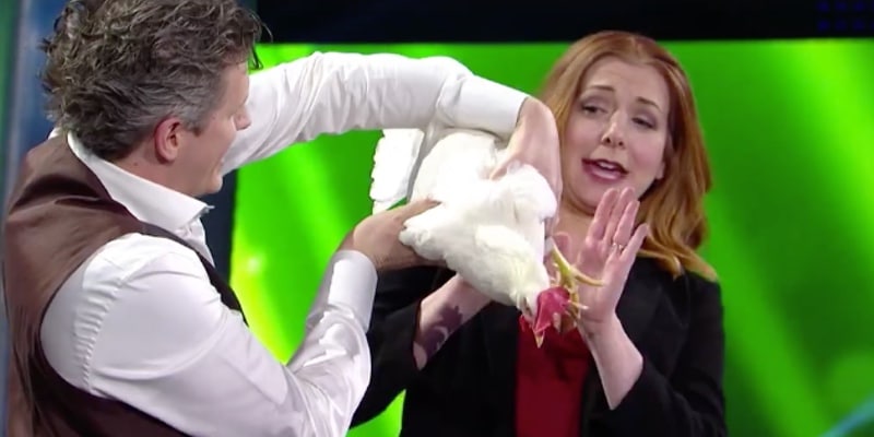 Alyson Hannigan backs off from a chicken's rear end as shes asked to check for any tricks