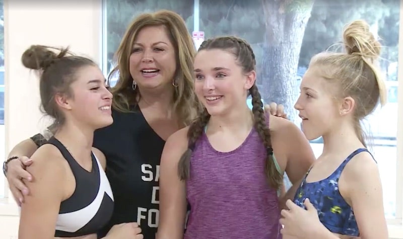Abby Lee Miller standing with some of her dancers on Dance Moms