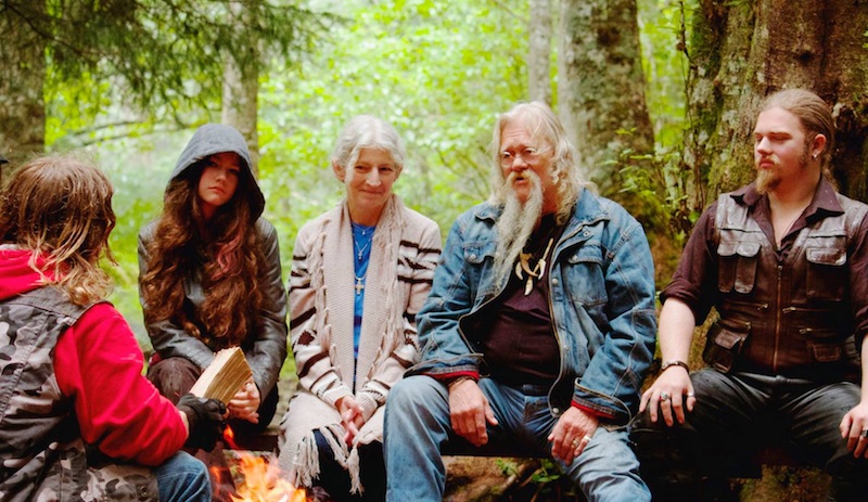 The Brown family sitting around a camp fire on Alaskan Bush People