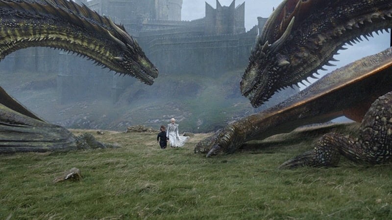 Daenerys and Tyrion walking on grass by her dragons on Game of Thrones: Beyond the Wall