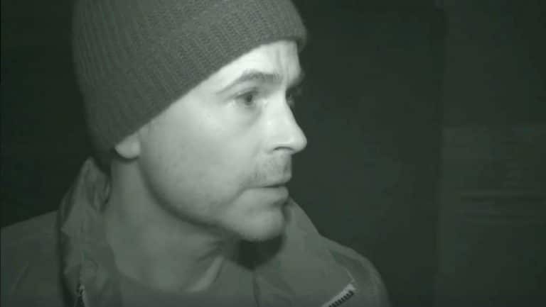 Rob Lowe inside Preston Castle at night with a light shining on his face on The Lowe Files