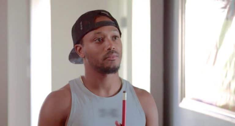 Romeo Miller holding a pool cue on Growing Up Hip Hop
