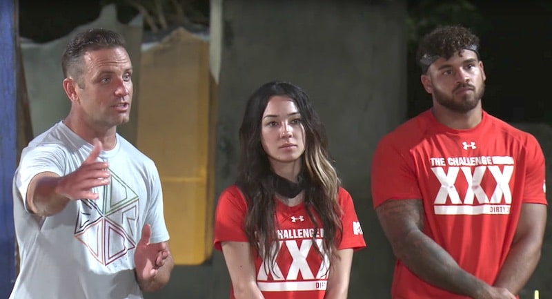 TJ Lavin standing next to players Briana and Cory on The Challenge XXX: Dirty Thirty