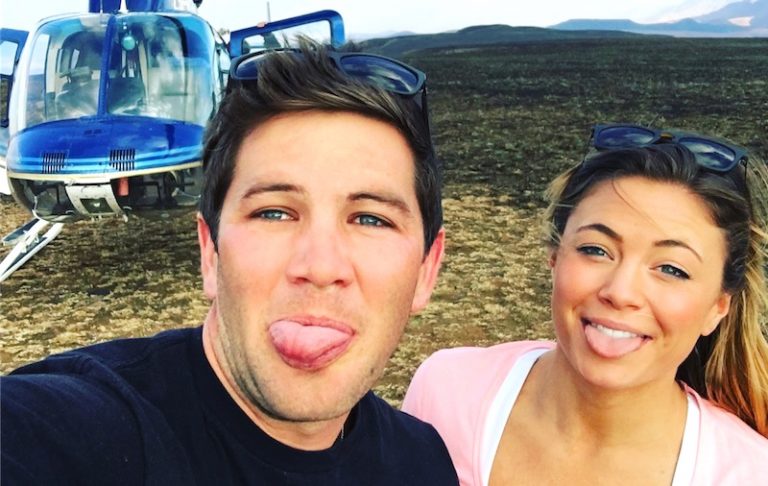 Below Deck Med's Malia White and Wes Walton posing in front of a helicopter in South Africa