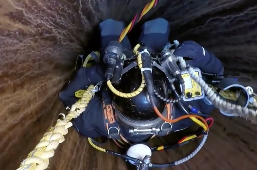 Diver being lowered down a shaft
