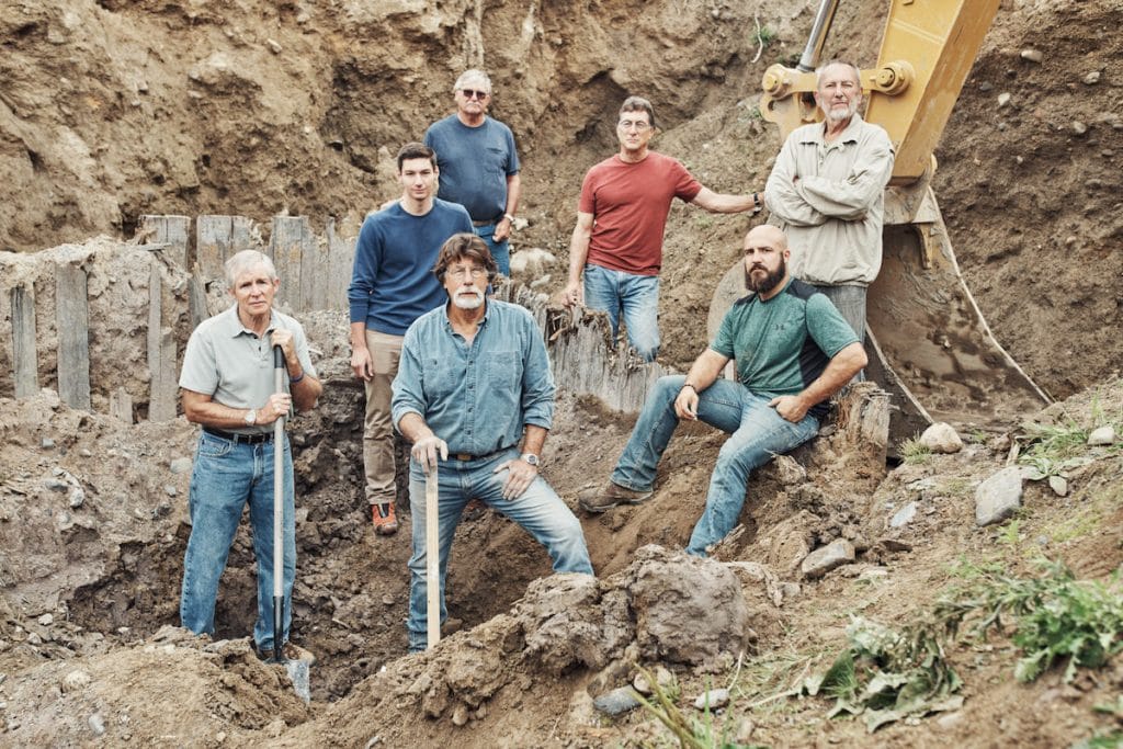 The team in the wood-lined pit on The Curse of Oak Island Season 5