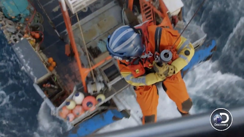 The rescuer heads down from the chopper on Deadliest Catch