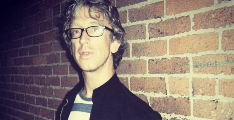 Andy Dick standing against a brick wall in a photo from Instagram