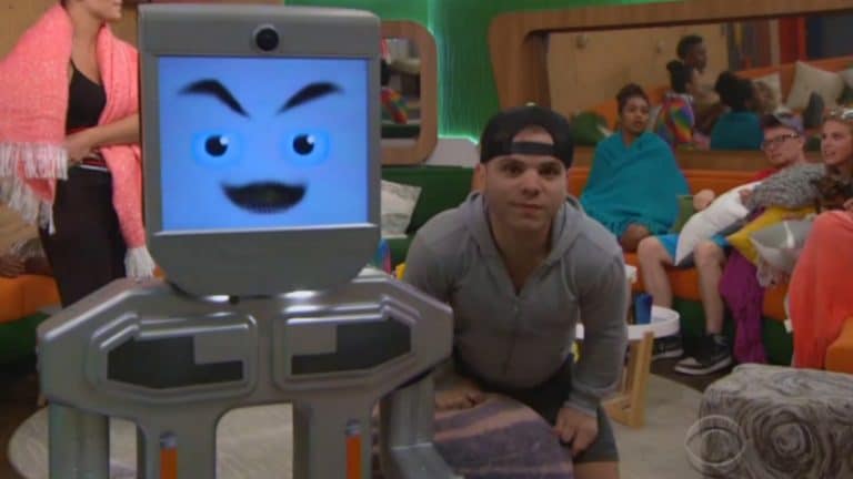 The BB20 computer and JC Monduix with the rest of the Big Brother 20 cast in the background