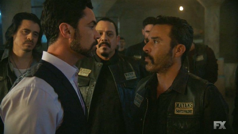 Still image from Mayans M.C. Escorpión/Dzec. President Bishop (Michael Irby) stands up to Miguel Galindo's brutality (Danny Pino). Pic credit: FX