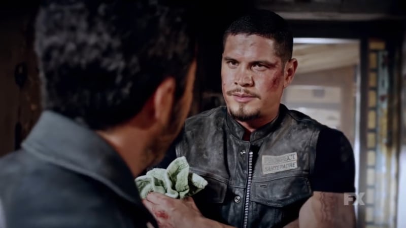 Still image from Mayans M.C. Cucaracha/K'uruch preview. President Bishop remarks on EZ's intellence as EZ appears injured. Pic Credit: FX