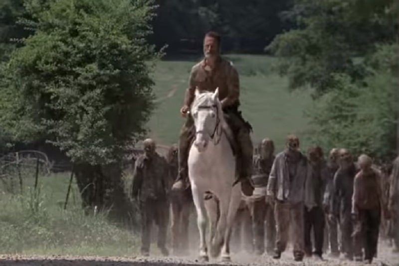 Rick Grimes (played by Andrew Lincoln) leads walkers on The Walking Dead