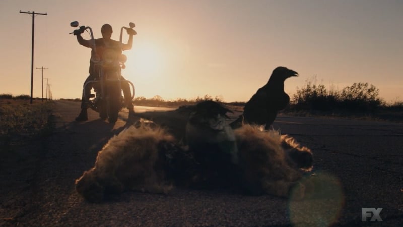Still Image from Mayans M.C. Cuervo/Tz'ikb'uul. The opening shot shows the reverse of the opening scene of the premiere episode as three crows eat the deceased dog on the roadside. Pic Credit: FX