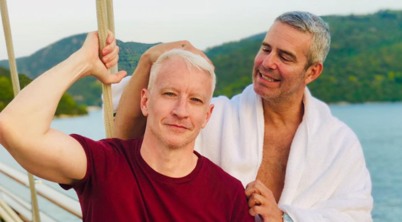 Anderson Cooper and Andy Cohen posing together on a boat