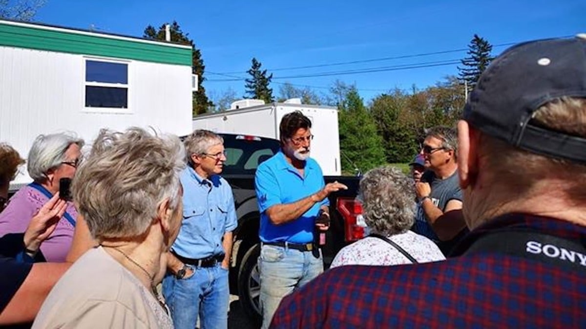 Craig Tester and Rick Lagina talk to people on an Oak Island tour