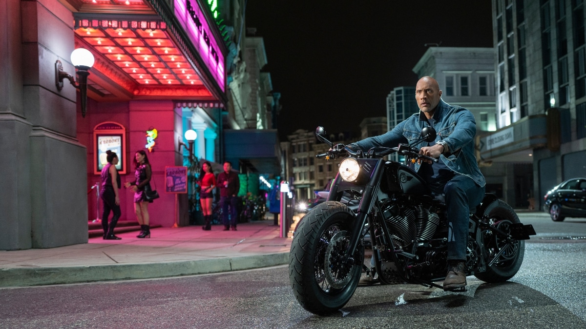 Dwayne Johnson as Luke Hobbs on a motorcycle in Hobbs and Shaw