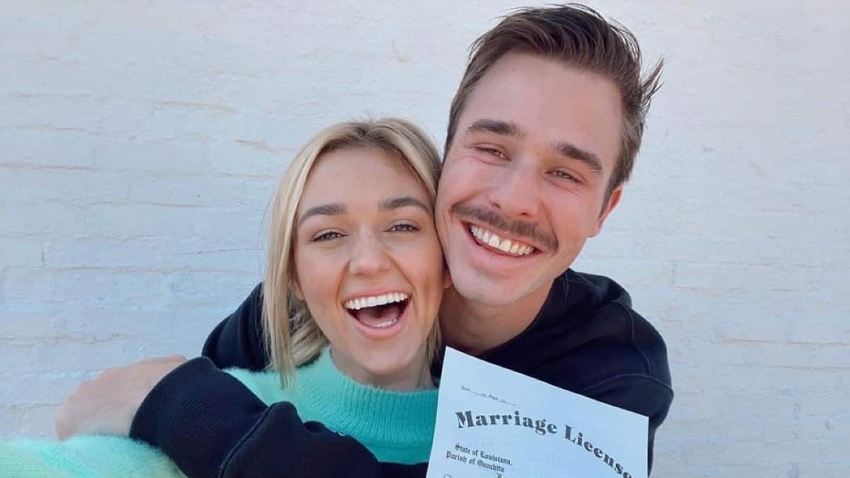 Sadie Robertson and Christian Huff posing with marriage license