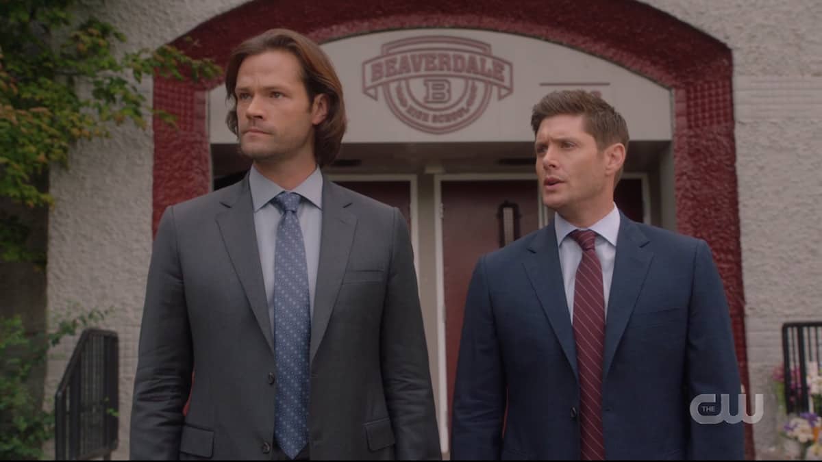Sam and Dean standing outside Beaverdale High School in Supernatural season 15 episode 4. Pic credit: the CW
