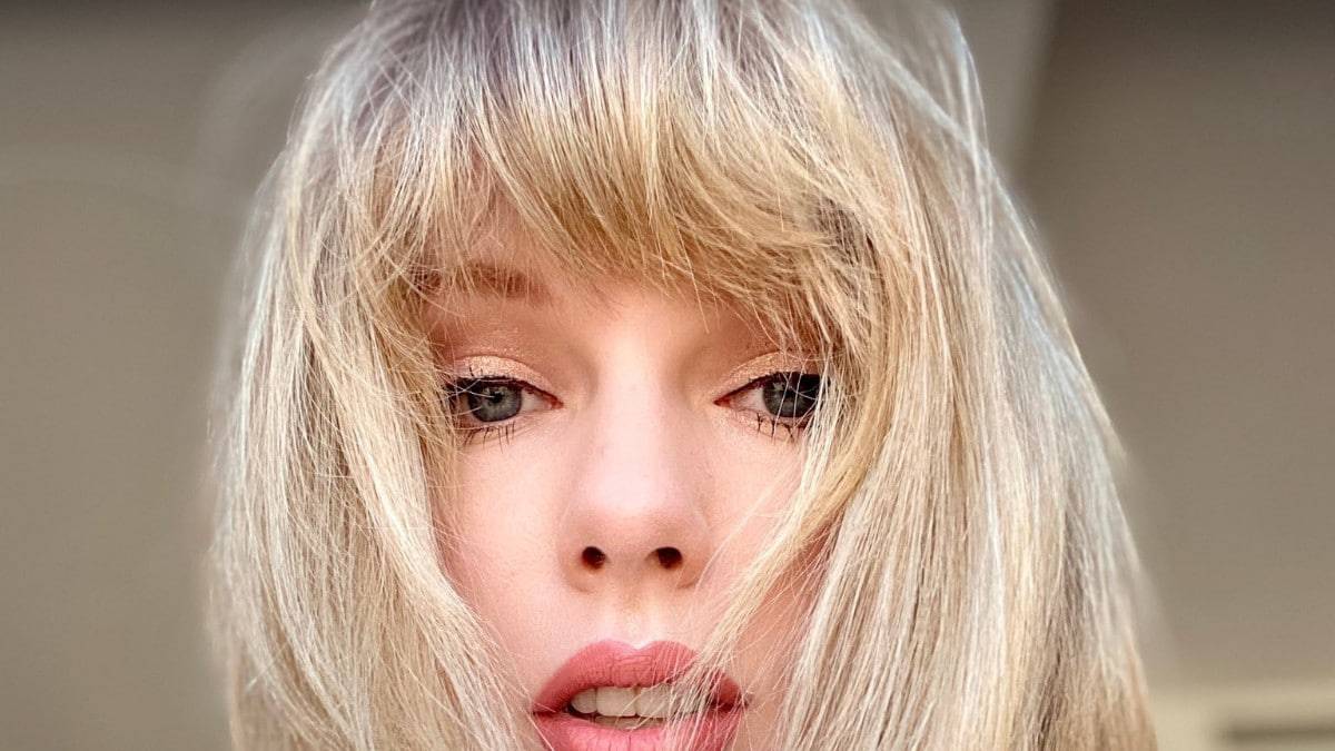 Taylor Swift posing for self shot video with fringe over face