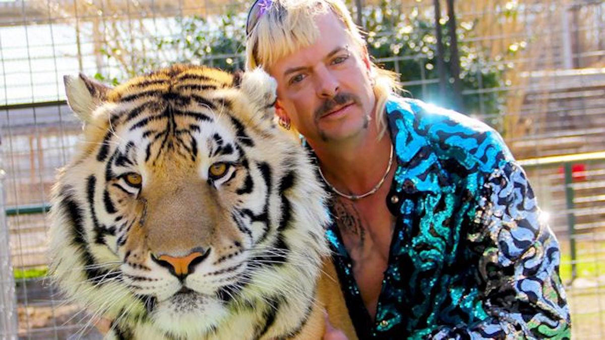 Joe Exotic poses with one of his tigers