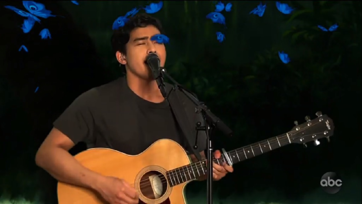 Francisco Martin singing near blue butterflies