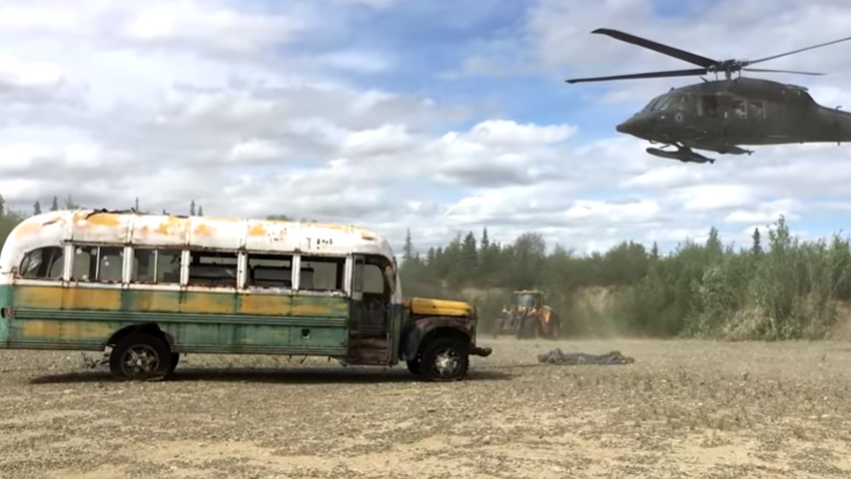 A helicopter approaches Alaska bus