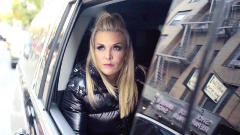 Tinsley Mortimer looks out of the window of a black car.