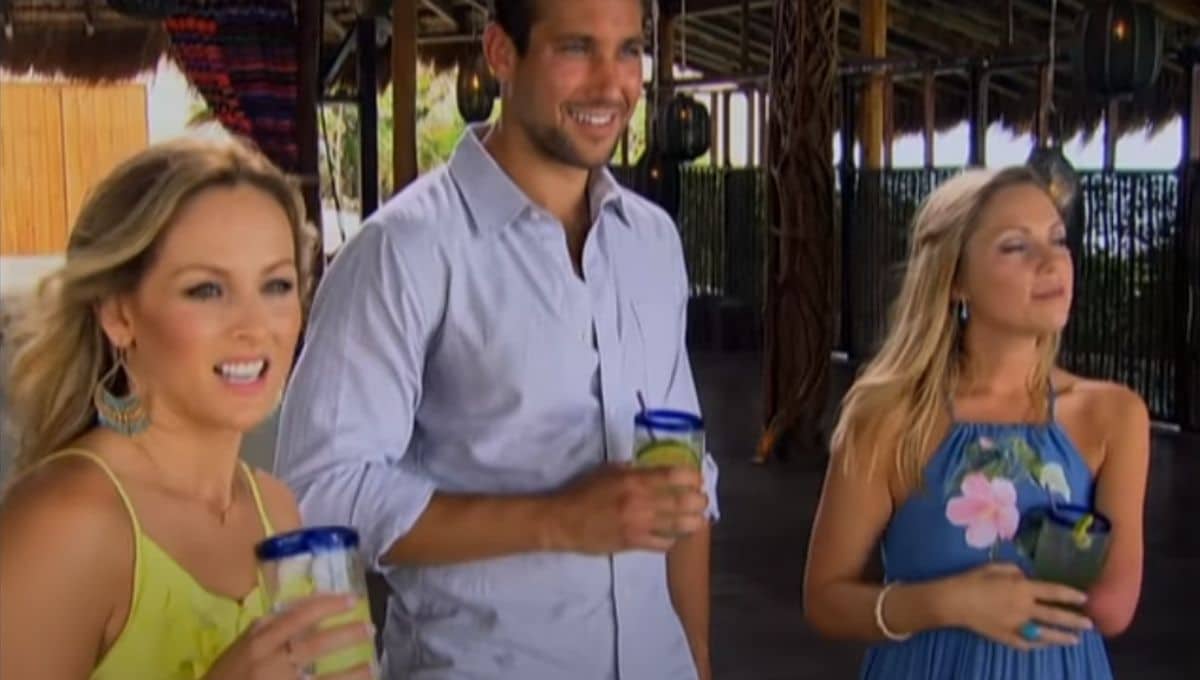 Clare Crawley stands in a yellow dress holding a drink next to two other contestants on Bachelor in Paradise 
