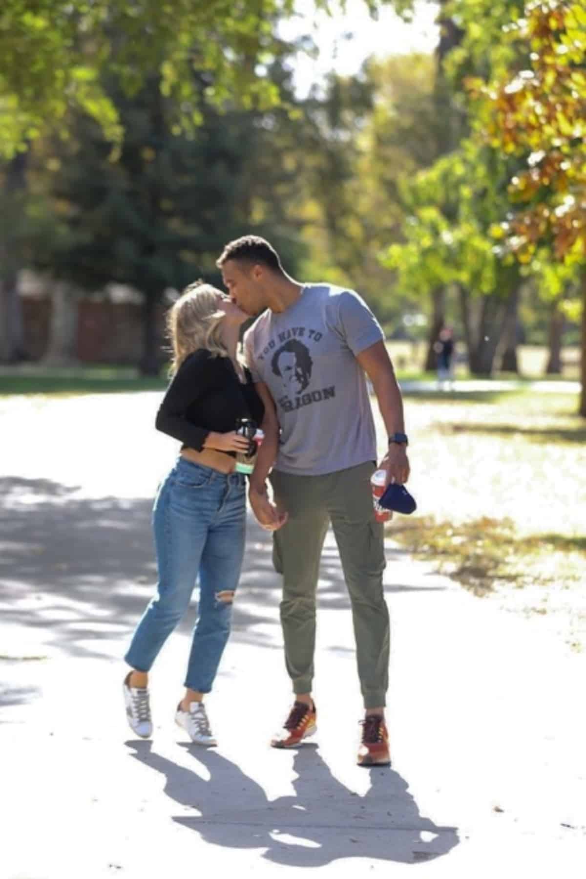 Clare Crawley and Dale Moss kiss while on a walk through McKinley Park in Sacramento 