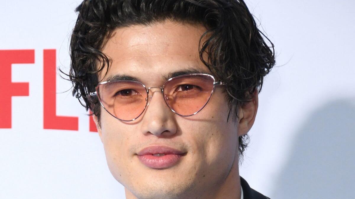 Image of Charles Melton at a press event.