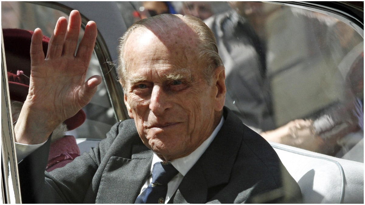 Prince Philip waving from a car