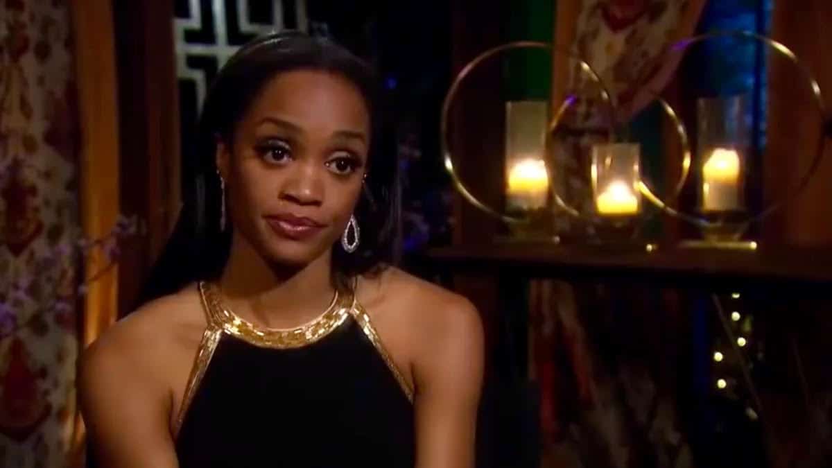 Rachel Lindsay stares into the camera wearing an evening gown