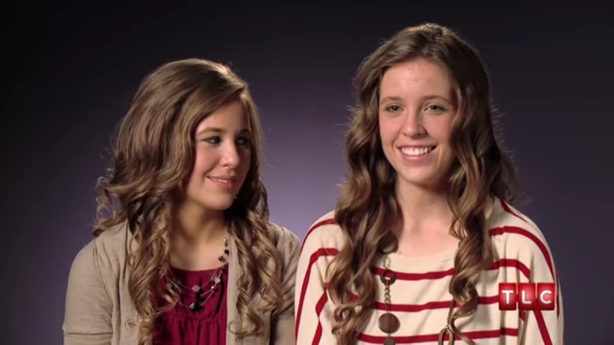 Jana and Jill Duggar in a 19 Kids and Counting confessional.
