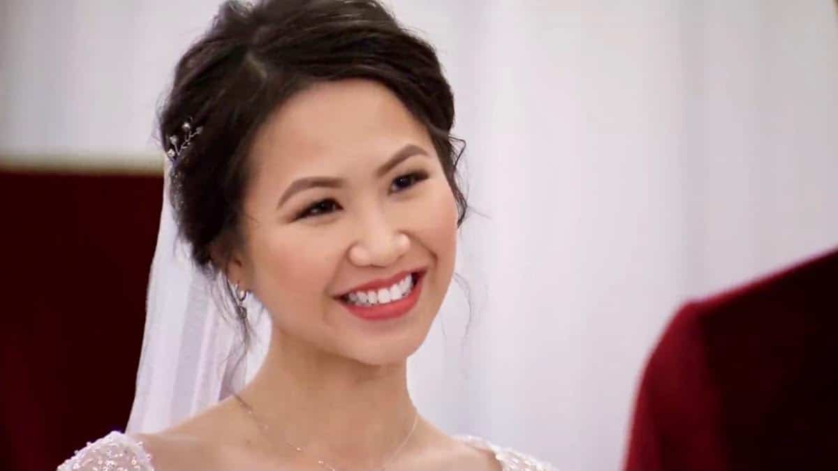 Bao smiles brightly in her wedding dress