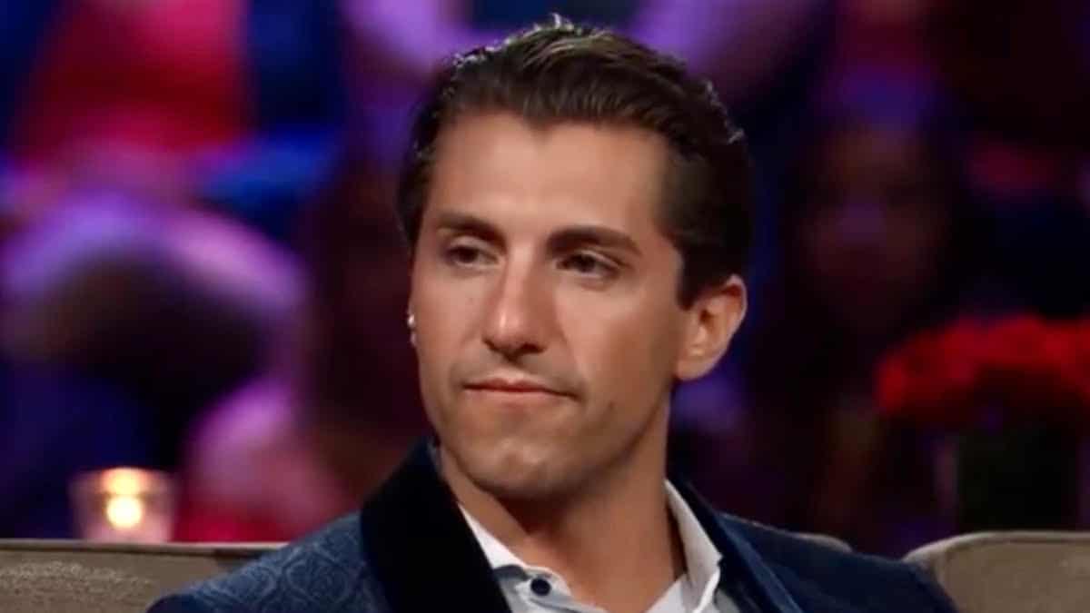 Jason Tartick sits and wears a suit