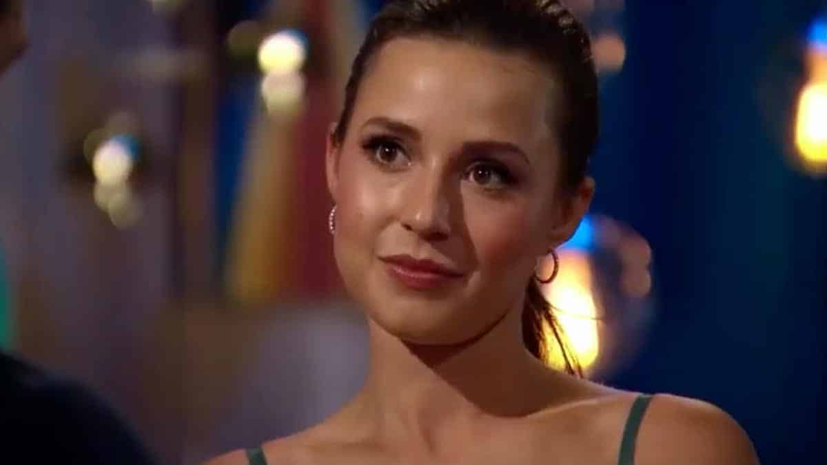 Katie Thurston smiles and wears her hair pulled back.