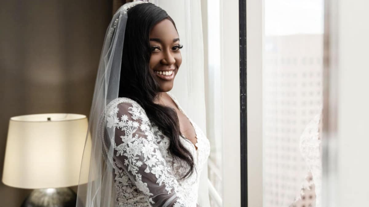 Paige Banks smiles in her wedding dress