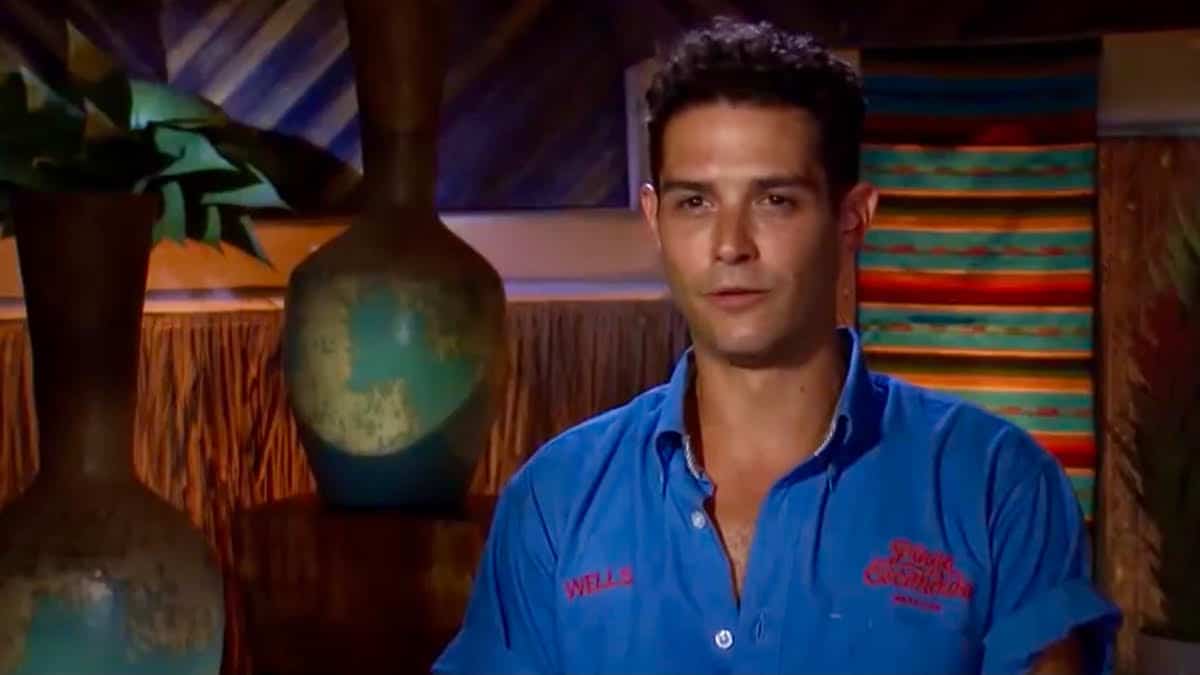 Wells Adams stares at the camera in his bar polo