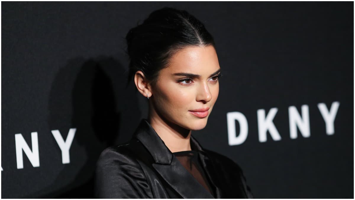 Kendall Jenner staring at the camera in an all-black outfit.