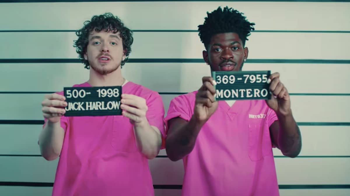 Jack Harlow and Lil Nas X pose as prisoners getting mugshots taken for the Industry Baby music video