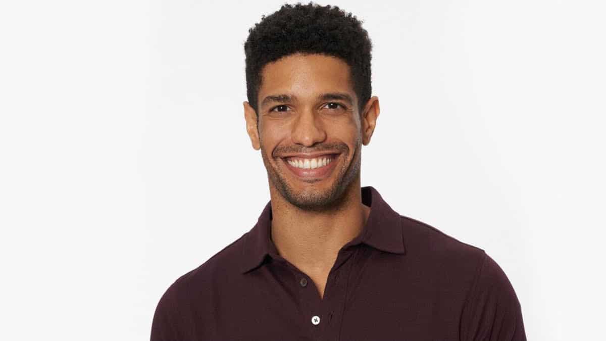 Romeo Alexander smiles wearing a collared shirt