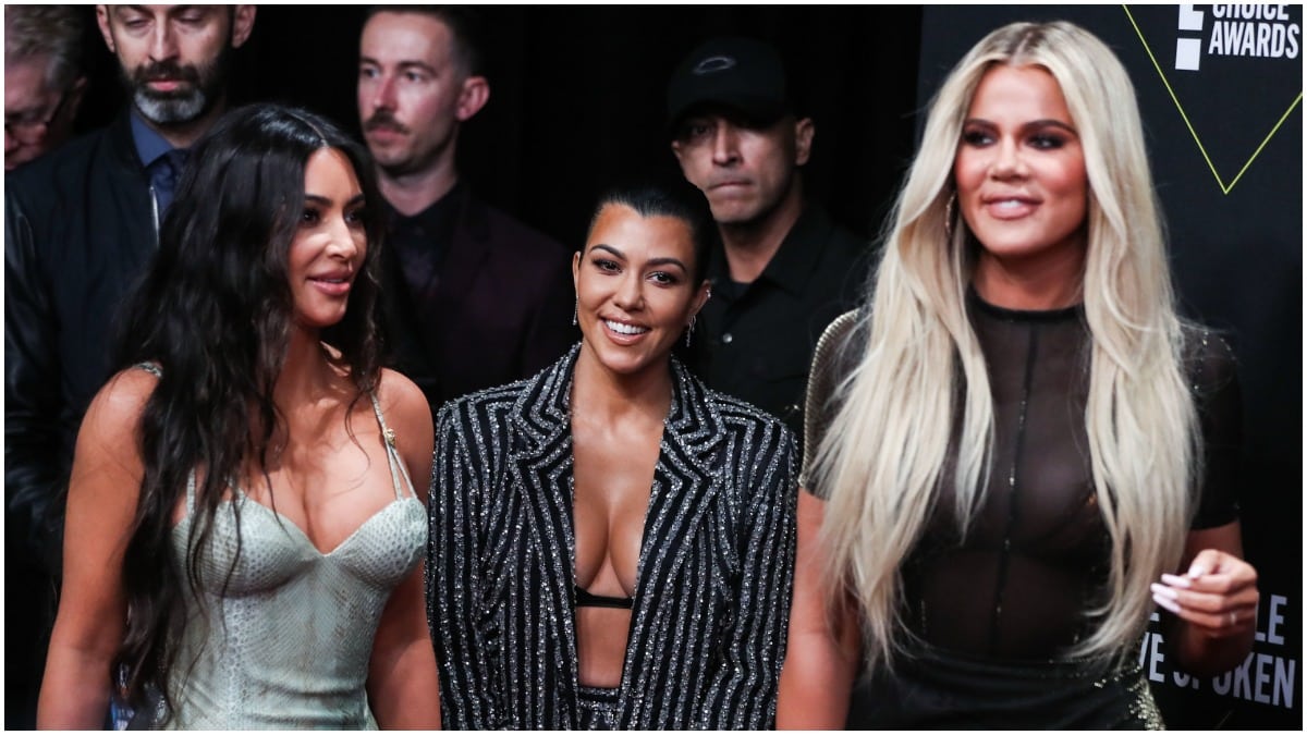 Kim Kardashian, Kourtney Kardashian, and Khloe Kardashian walking on the red carpet.