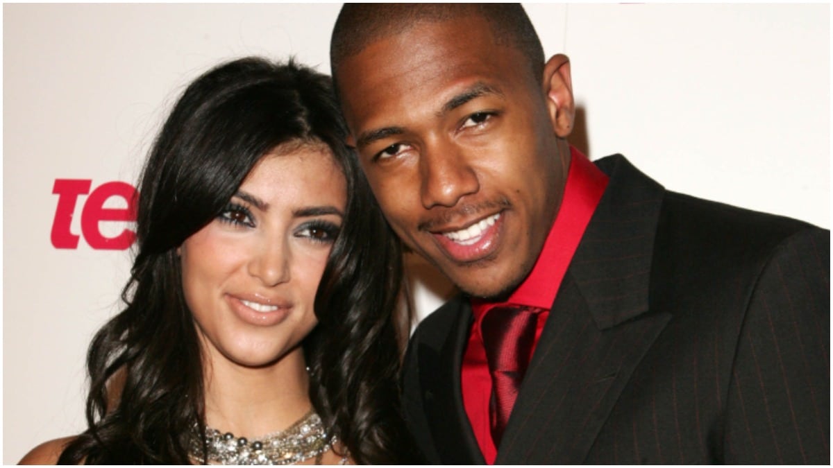 Kim Kardashian and Nick Cannon smiling at a red carpet event.
